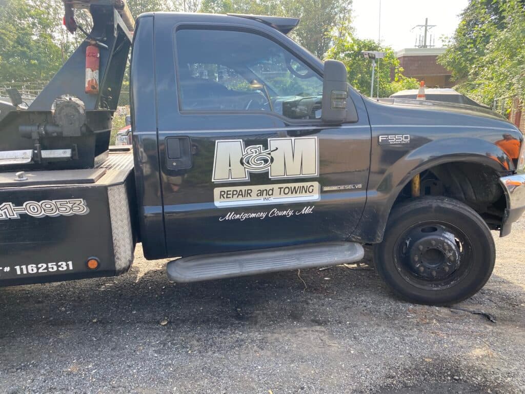 A&M Repair & Towing black Ford wrecker truck